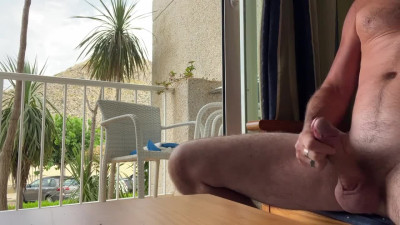 Man stroking cock in hotel