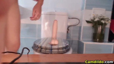 Busty Babe fucks a dildo in the bathroom